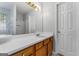 Bathroom featuring wood cabinets, white countertops, and a large mirror at 520 Lakecourt Dr, Mcdonough, GA 30253