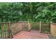 Wooden deck offering a view of backyard with a mature tree line at 520 Lakecourt Dr, Mcdonough, GA 30253