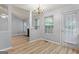 The dining room is adjacent to the living room and features a modern chandelier at 520 Lakecourt Dr, Mcdonough, GA 30253