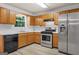 Updated kitchen featuring stainless steel appliances, wooden cabinets, and modern fixtures at 520 Lakecourt Dr, Mcdonough, GA 30253
