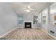 Open-concept living room with fireplace and large windows offering abundant natural light at 520 Lakecourt Dr, Mcdonough, GA 30253