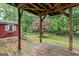 Covered patio featuring wooden post-and-beam construction and mature backyard landscaping at 520 Lakecourt Dr, Mcdonough, GA 30253