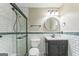 Updated bathroom features glass shower, black vanity, and subway tile at 195 Southmoor Cir, Stockbridge, GA 30281