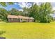 Classic brick home with a large front yard and mature trees, exuding a warm and welcoming atmosphere at 195 Southmoor Cir, Stockbridge, GA 30281
