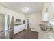 Charming kitchen features white cabinets, stainless steel appliances, and granite countertops at 195 Southmoor Cir, Stockbridge, GA 30281