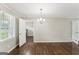 Open living area with hardwood floors, natural light and modern chandelier at 195 Southmoor Cir, Stockbridge, GA 30281