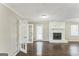 Open living room with gleaming hardwood floors and a white brick fireplace as a main focal point at 195 Southmoor Cir, Stockbridge, GA 30281