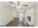 Bright and spacious living room with a brick fireplace and wood floors offers a welcoming atmosphere at 195 Southmoor Cir, Stockbridge, GA 30281