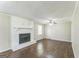 Bright living room features a painted brick fireplace, ceiling fan and hardwood floors at 195 Southmoor Cir, Stockbridge, GA 30281