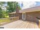 Back deck view of a brick home with wood railing at 195 Southmoor Cir, Stockbridge, GA 30281