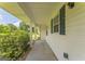 Cozy side porch with view of the neighborhood and mature landscaping at 195 Southmoor Cir, Stockbridge, GA 30281