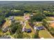 Expansive aerial view of a luxury home surrounded by lush greenery and manicured lawns in an upscale neighborhood at 100 Regina Ct, Fayetteville, GA 30215
