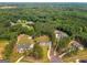 Stunning aerial shot of an estate home nestled within a verdant landscape, showcasing its grand setting and privacy at 100 Regina Ct, Fayetteville, GA 30215