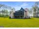 Lush backyard featuring a screened porch and brick exterior, perfect for outdoor relaxation and entertaining at 100 Regina Ct, Fayetteville, GA 30215