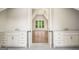 Dual sink bathroom vanity leading to bright and spacious room with vaulted ceiling and hardwood floors at 100 Regina Ct, Fayetteville, GA 30215