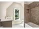 Bathroom with a stylish vanity, soaking tub, and a window that offers a view of the outdoors at 100 Regina Ct, Fayetteville, GA 30215