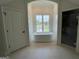 Luxurious bathroom featuring a freestanding tub with a window view and neutral tile at 100 Regina Ct, Fayetteville, GA 30215
