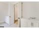 Bright bathroom featuring a sink vanity and walk through door to another part of the home at 100 Regina Ct, Fayetteville, GA 30215