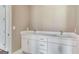 Bathroom vanity with dual sinks, white cabinets, and marble countertops at 100 Regina Ct, Fayetteville, GA 30215