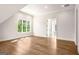 Spacious bedroom with hardwood floors, a large window, and an open doorway at 100 Regina Ct, Fayetteville, GA 30215