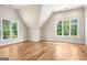 An attic bedroom features hardwood flooring and large windows providing ample natural light and scenic views at 100 Regina Ct, Fayetteville, GA 30215