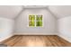 Bright bedroom featuring hardwood floors and a large window with outdoor views at 100 Regina Ct, Fayetteville, GA 30215