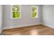 Spacious bedroom with hardwood floors and large windows offering serene views at 100 Regina Ct, Fayetteville, GA 30215