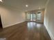 An empty bonus room with dark wood floors and access to outdoor deck through french doors at 100 Regina Ct, Fayetteville, GA 30215
