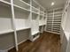 Spacious walk-in closet with custom shelving and hardwood floors at 100 Regina Ct, Fayetteville, GA 30215