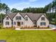 Light brick two-story home with manicured lawn and professional landscaping at 100 Regina Ct, Fayetteville, GA 30215