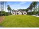 Sprawling two-story home on a large lot with lush green lawn and mature trees at 100 Regina Ct, Fayetteville, GA 30215