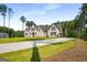 Stately brick home with manicured lawn and long driveway offers curb appeal and luxurious living at 100 Regina Ct, Fayetteville, GA 30215