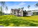 Expansive lawn and brick home featuring a screened porch and multi-car garage in a serene setting at 100 Regina Ct, Fayetteville, GA 30215