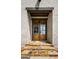 Close-up of double front doors with stone steps and light brick exterior at 100 Regina Ct, Fayetteville, GA 30215