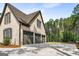 Spacious three-car garage with brick exterior, offering ample parking and storage space at 100 Regina Ct, Fayetteville, GA 30215