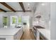 Modern kitchen with island, pot filler, and easy access to the living area and fireplace at 100 Regina Ct, Fayetteville, GA 30215