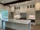 Modern kitchen with white cabinets, quartz countertops, and a large center island at 100 Regina Ct, Fayetteville, GA 30215