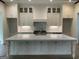 Spacious kitchen features a large island with white cabinets and a marble countertop at 100 Regina Ct, Fayetteville, GA 30215
