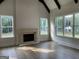 Living room with a stone fireplace and large windows showcasing natural light and outdoor views at 100 Regina Ct, Fayetteville, GA 30215