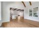 Spacious open-concept living area with wood floors, exposed beams, and seamless flow to the kitchen and entryway at 100 Regina Ct, Fayetteville, GA 30215