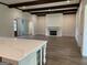 Bright living room featuring hardwood floors, dark wood beams, and a stone fireplace at 100 Regina Ct, Fayetteville, GA 30215