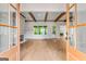 Bright living room with hardwood floors, exposed beams, and cozy fireplace at 100 Regina Ct, Fayetteville, GA 30215