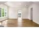 Spacious living room featuring hardwood floors, large windows, and open doorway at 100 Regina Ct, Fayetteville, GA 30215