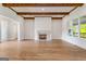 Bright living room with hardwood floors, white walls, and charming fireplace at 100 Regina Ct, Fayetteville, GA 30215