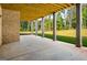 Covered patio with brick accents and sturdy columns provides a shaded outdoor living space with backyard views at 100 Regina Ct, Fayetteville, GA 30215