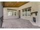 Covered patio showcases a painted brick fireplace, wood ceiling, and an inviting space to relax and entertain at 100 Regina Ct, Fayetteville, GA 30215