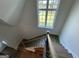 View looking down the staircase with wooden handrail and iron spindles at 100 Regina Ct, Fayetteville, GA 30215