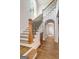 Elegant staircase featuring wood treads, black iron railings, and an arched hallway at 100 Regina Ct, Fayetteville, GA 30215