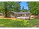 Charming backyard view with deck, green lawn, and well-maintained landscaping at 810 Bedford Park, Peachtree City, GA 30269
