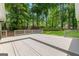 Large backyard deck overlooking lush, mature landscaping and partial fencing for privacy at 810 Bedford Park, Peachtree City, GA 30269